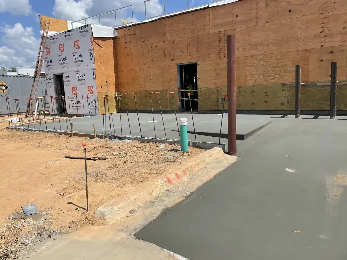 Fresh concrete slab and curb at a commercial building under construction