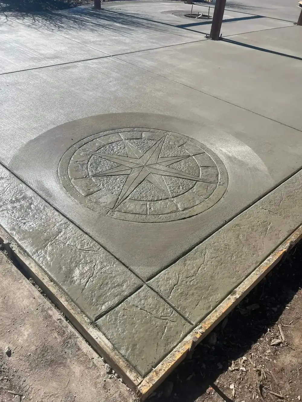 Stamped concrete with a compass medallion and textured border